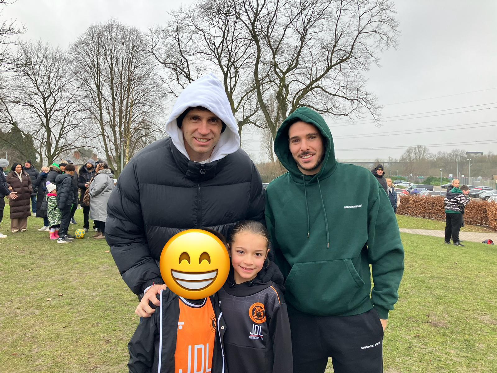 Xander meeting two professional footballers on the touchline at a grassroots game