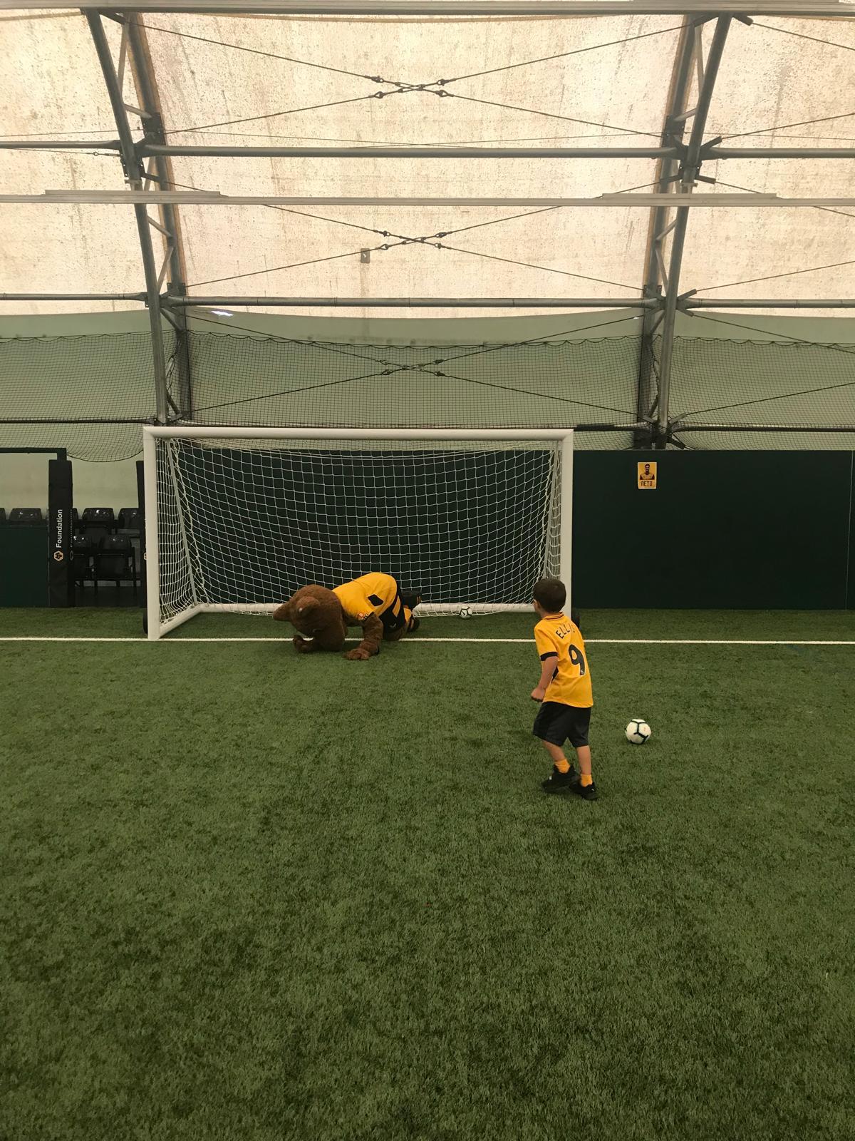 Xander taking a penalty against a mascot goalkeeper