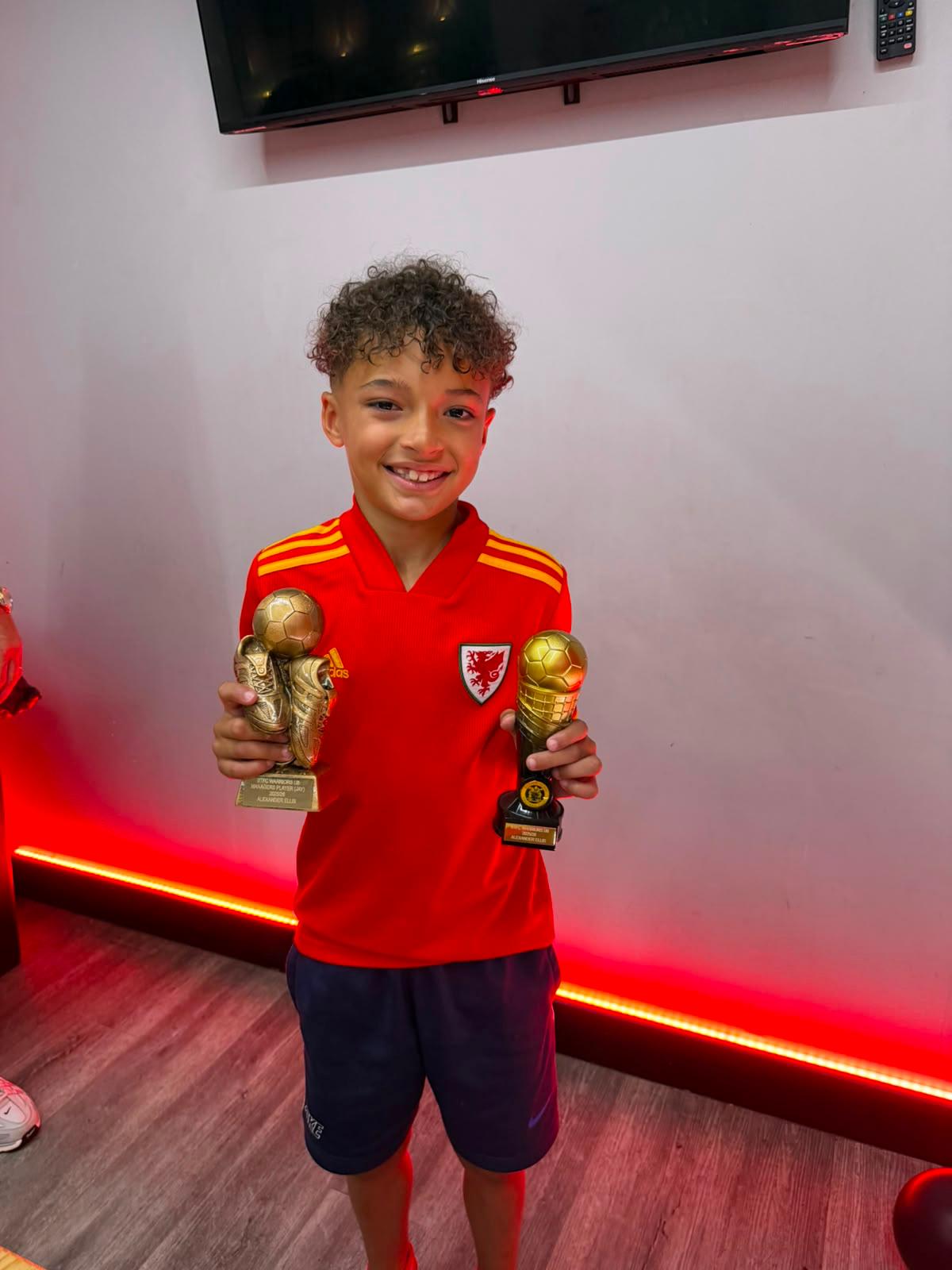 Xander holding his winners' medal after the final